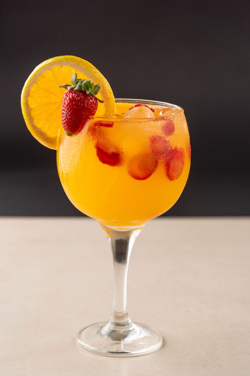 Drink de laranja com morango na borda da taça